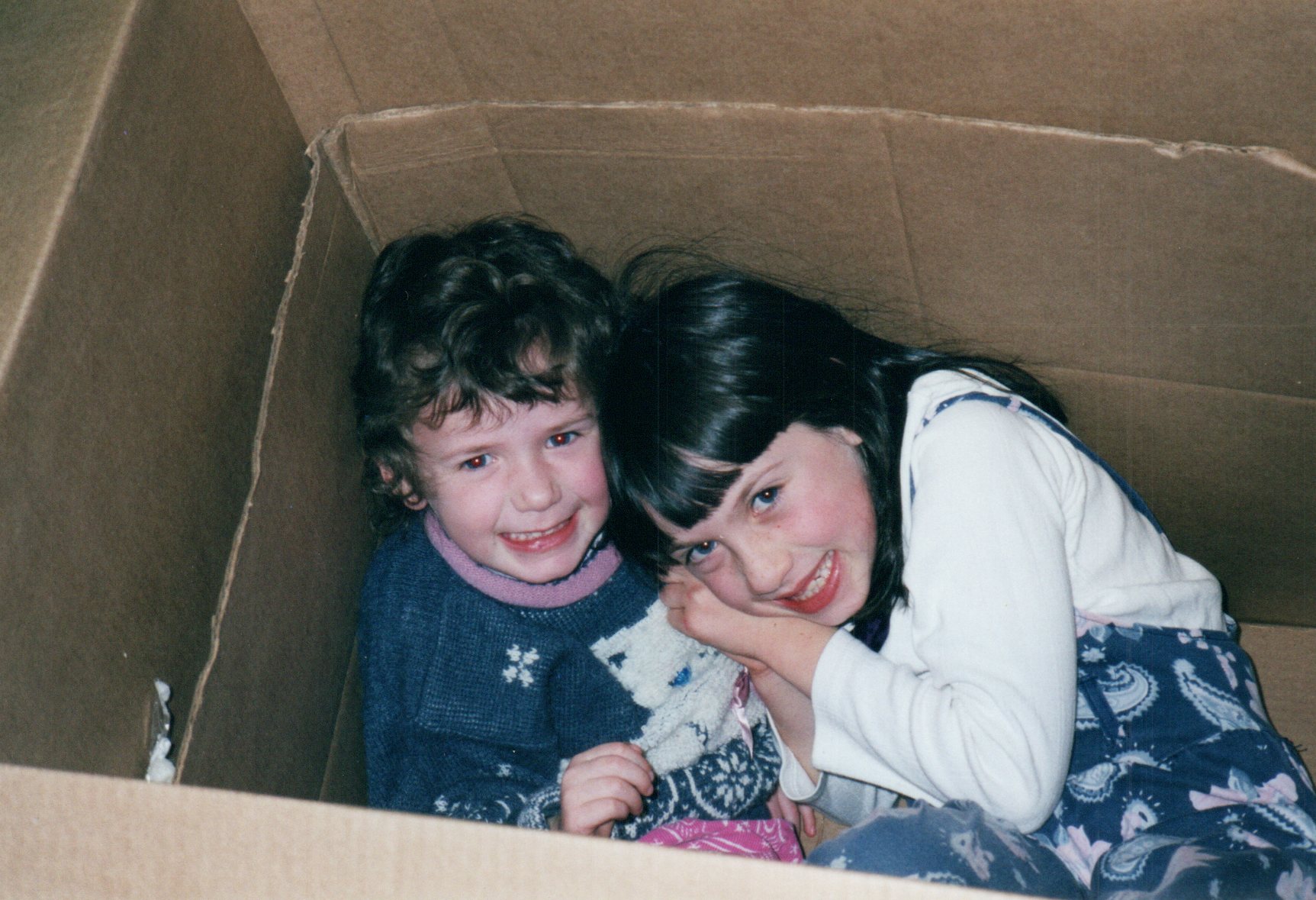 two children in a charboard box